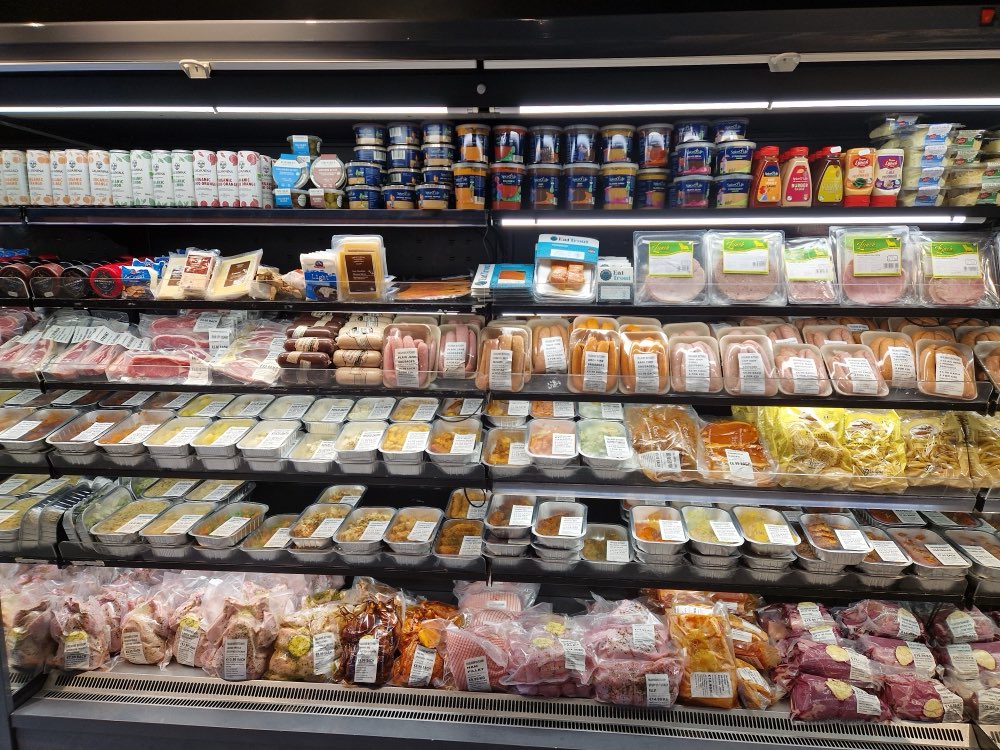 The deli chiller stocked with cooked meats, cheeses and dips at Faulkner Butchery